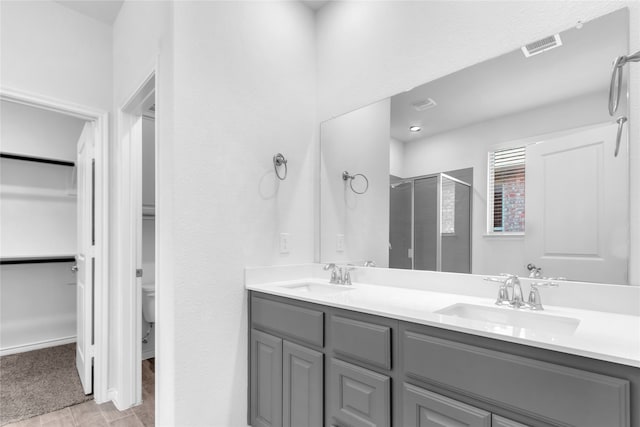 bathroom featuring vanity, a shower with shower door, hardwood / wood-style flooring, and toilet