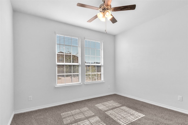 carpeted spare room with ceiling fan and a wealth of natural light