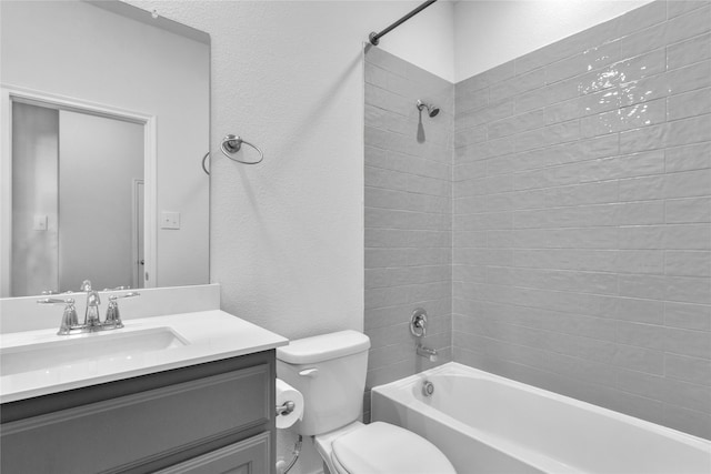 full bathroom featuring vanity, toilet, and tiled shower / bath