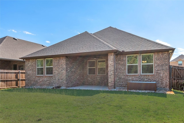 rear view of property with a yard and a patio