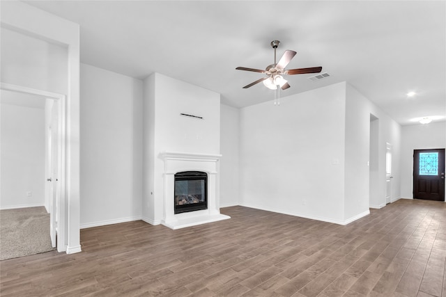 unfurnished living room with ceiling fan and hardwood / wood-style flooring