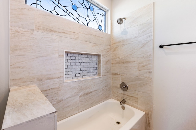 bathroom featuring tiled shower / bath and a wealth of natural light