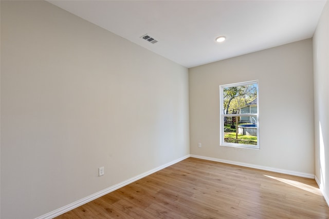 empty room with light hardwood / wood-style floors