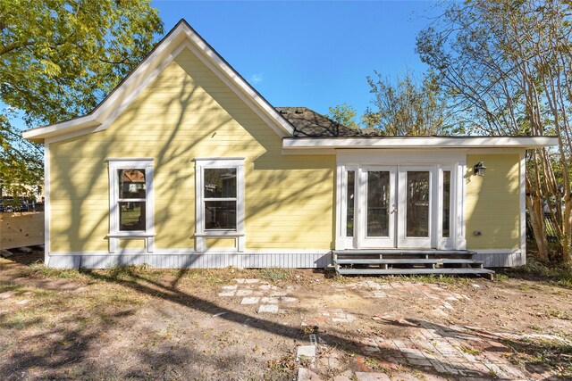 rear view of house featuring french doors