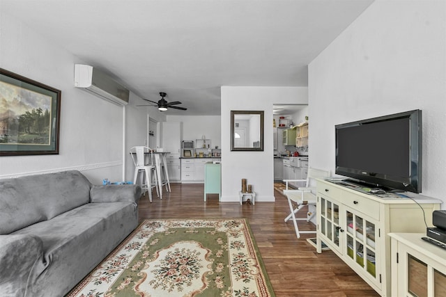 living room featuring ceiling fan, a wall unit AC, and dark hardwood / wood-style flooring