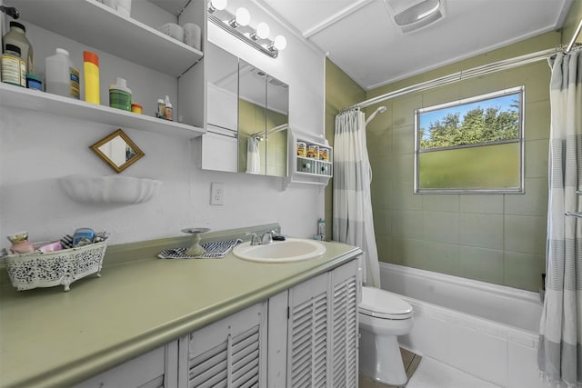 full bathroom featuring vanity, shower / bath combo with shower curtain, toilet, and tile patterned flooring