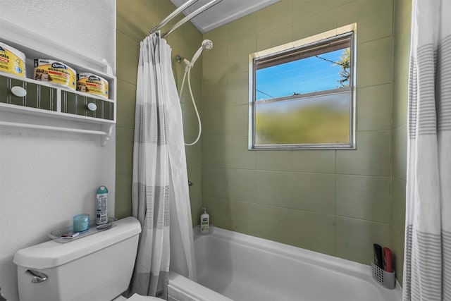 bathroom with shower / bath combo with shower curtain and toilet