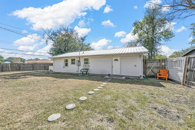 back of house with a lawn