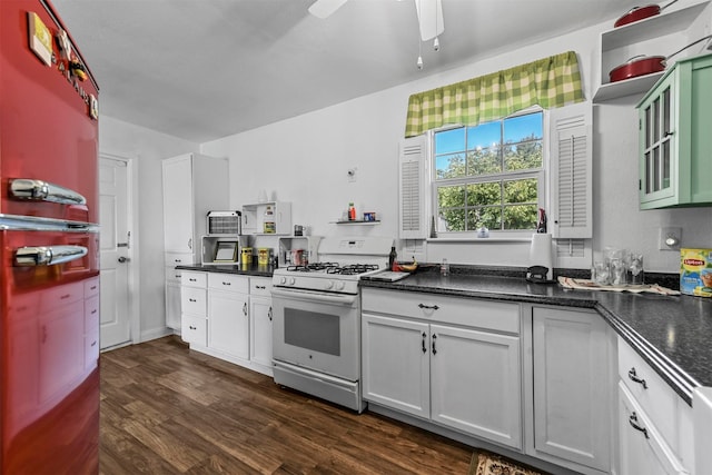 kitchen with white range with gas cooktop, dark hardwood / wood-style floors, white cabinetry, and ceiling fan