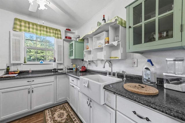 kitchen with ceiling fan, white cabinetry, dark hardwood / wood-style floors, sink, and green cabinetry