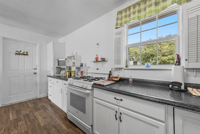 kitchen featuring white cabinetry, gas range gas stove, and dark wood-type flooring