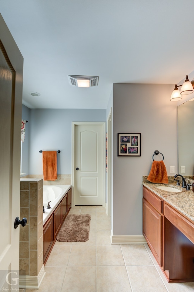 bathroom with vanity, a tub to relax in, and tile patterned floors