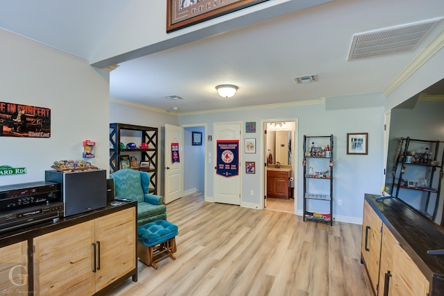 interior space featuring ornamental molding and light hardwood / wood-style floors