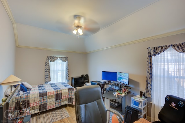 bedroom featuring crown molding, hardwood / wood-style flooring, and ceiling fan