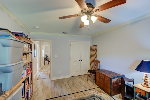 office with ornamental molding, light wood-type flooring, and ceiling fan