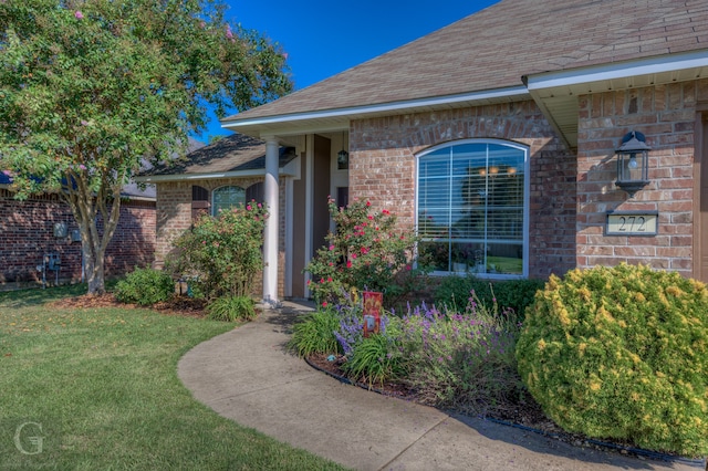 property entrance with a yard