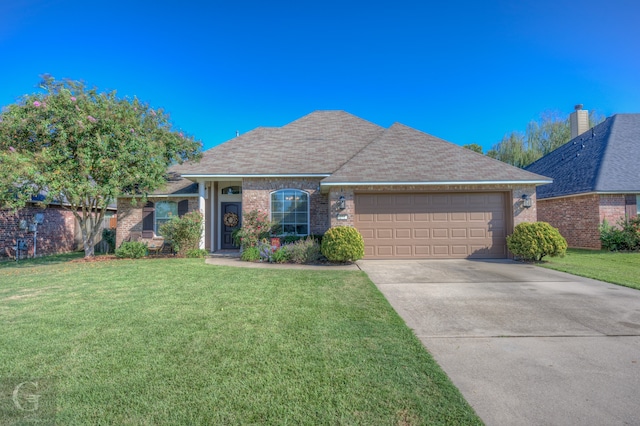 view of front of property with a garage and a front lawn