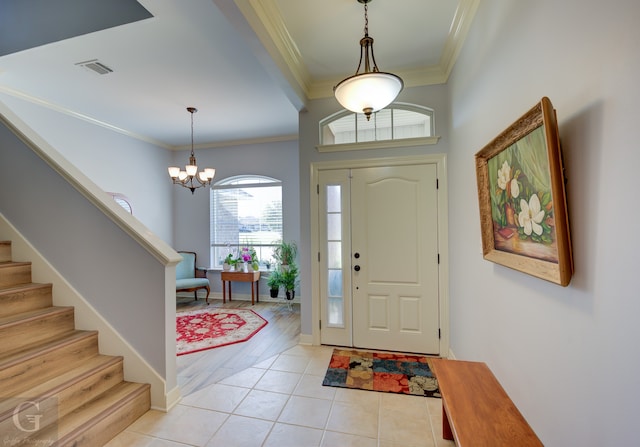 entryway featuring a notable chandelier, light hardwood / wood-style floors, and crown molding