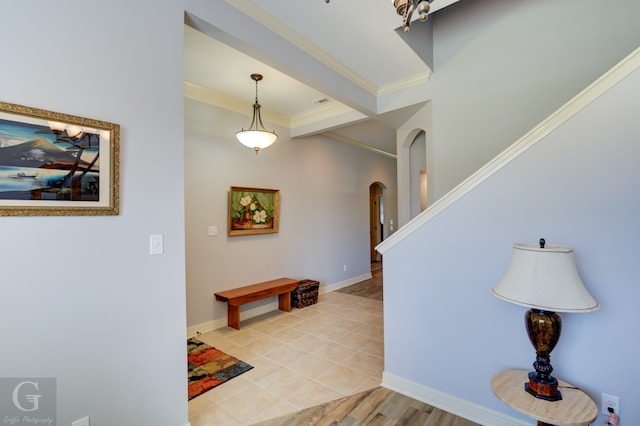 foyer entrance with ornamental molding and light hardwood / wood-style floors