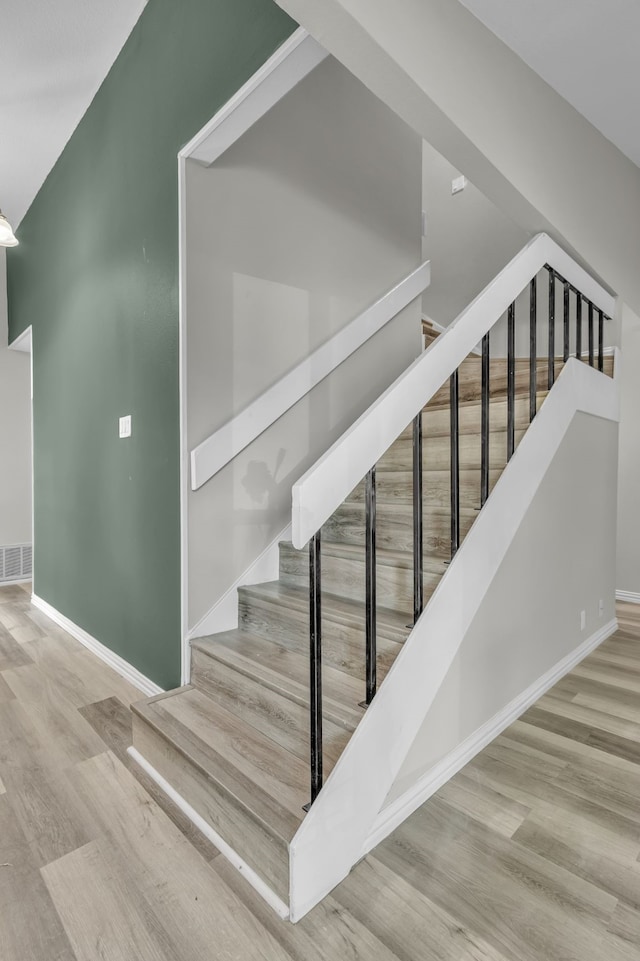 stairs with wood-type flooring