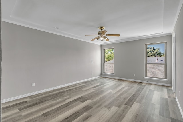 empty room with light hardwood / wood-style floors, ornamental molding, and ceiling fan