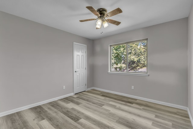 empty room with light hardwood / wood-style floors and ceiling fan