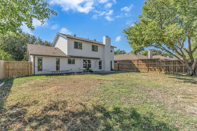 rear view of house with a yard and a patio area