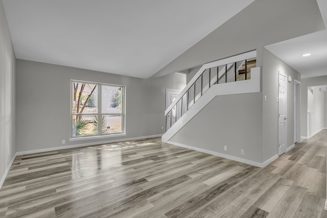 unfurnished living room with light hardwood / wood-style flooring and vaulted ceiling