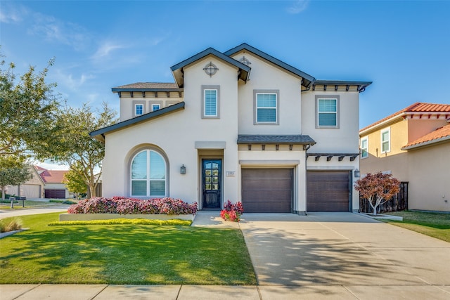 mediterranean / spanish house featuring a garage and a front lawn