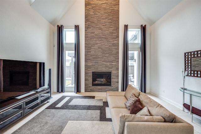 living room with a fireplace, high vaulted ceiling, and light tile patterned flooring