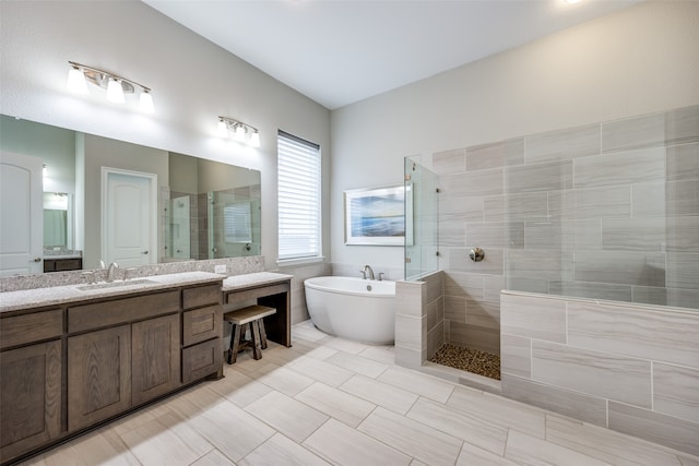 bathroom featuring vanity and independent shower and bath