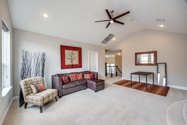 living room featuring ceiling fan, lofted ceiling, and light carpet