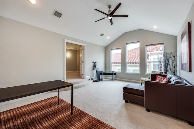 living room with vaulted ceiling, light colored carpet, and ceiling fan