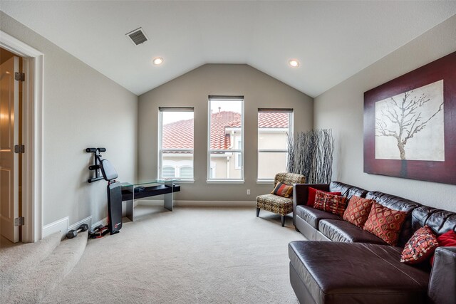 living room featuring lofted ceiling and light carpet