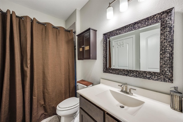 bathroom featuring a shower with curtain, vanity, and toilet