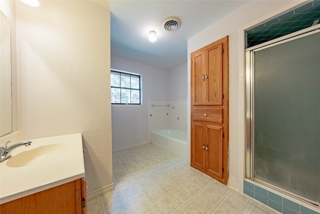 bathroom with vanity and independent shower and bath