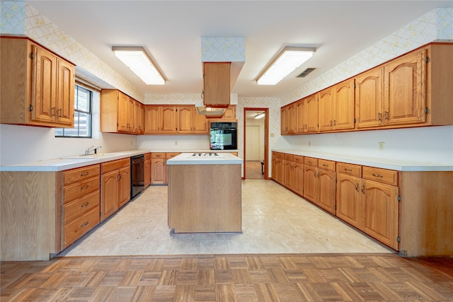 kitchen with black appliances, light parquet floors, and a kitchen island