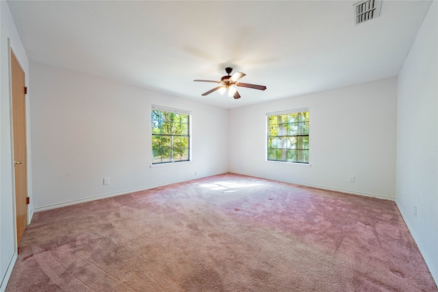 carpeted empty room featuring ceiling fan