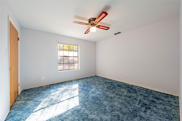 carpeted spare room with ceiling fan