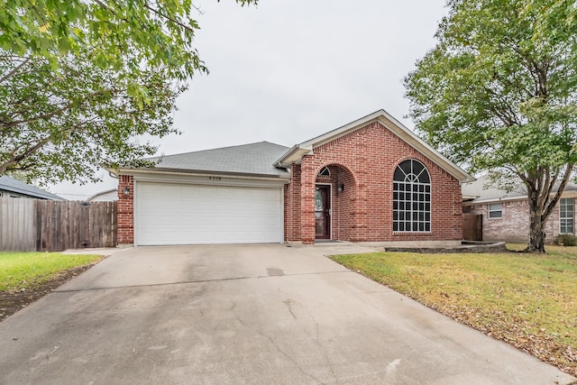 view of front facade with a front yard and a garage