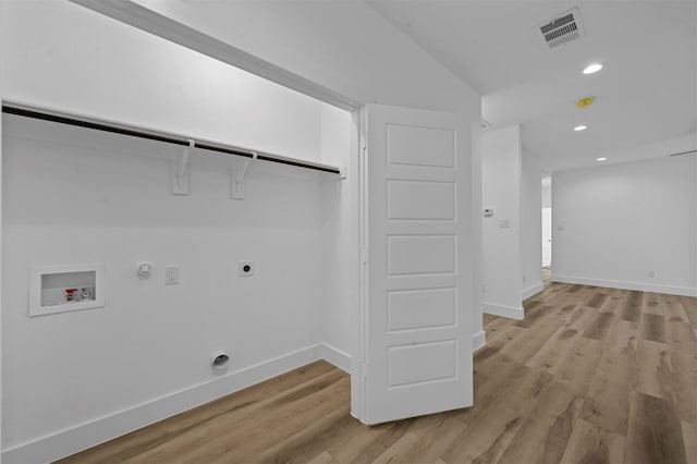 washroom featuring light wood-type flooring, electric dryer hookup, gas dryer hookup, and washer hookup