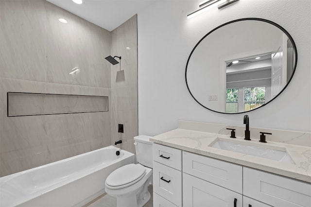 full bathroom featuring tiled shower / bath, toilet, and vanity