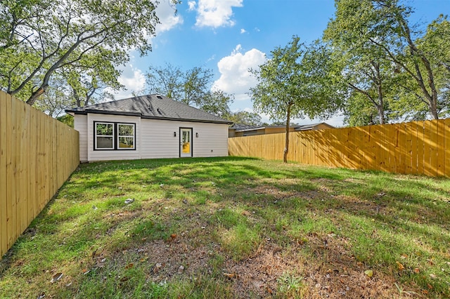 rear view of property with a lawn