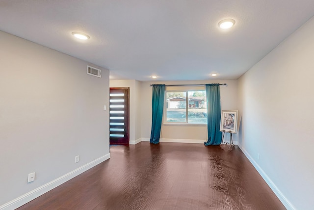 unfurnished room with dark hardwood / wood-style floors