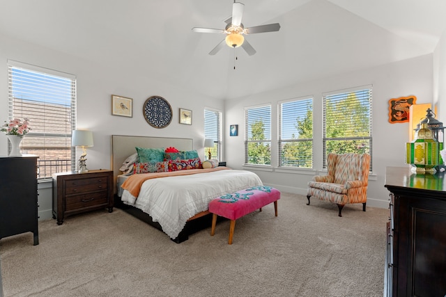 carpeted bedroom with vaulted ceiling, multiple windows, and ceiling fan