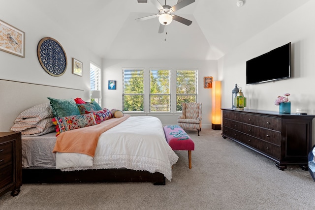 bedroom with vaulted ceiling, light colored carpet, and ceiling fan