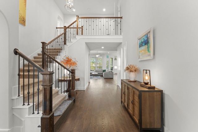 foyer featuring a high ceiling, a notable chandelier, and dark hardwood / wood-style flooring