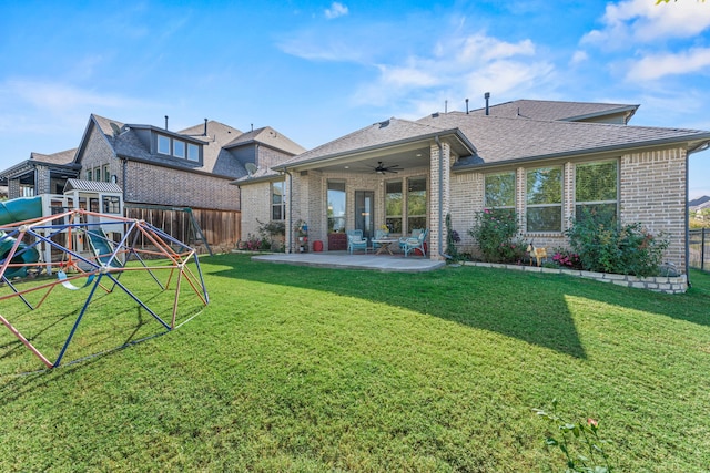 back of house featuring a patio area, a lawn, and ceiling fan