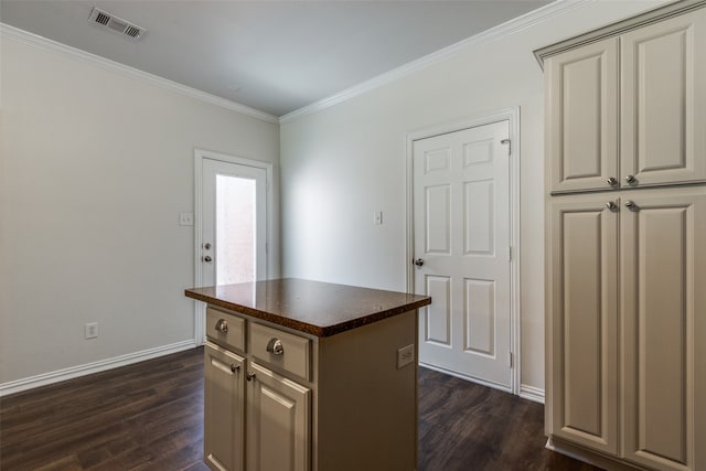 kitchen with crown molding, dark hardwood / wood-style floors, and a center island