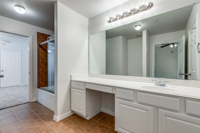 bathroom featuring combined bath / shower with glass door, tile patterned flooring, vanity, and ceiling fan